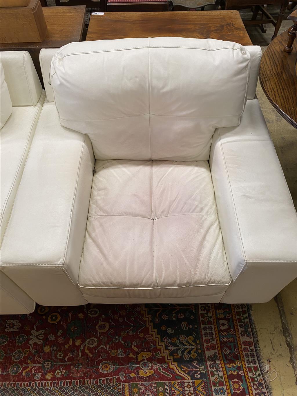 A pair of contemporary white leather armchairs, width 104cm, depth 98cm, height 88cm